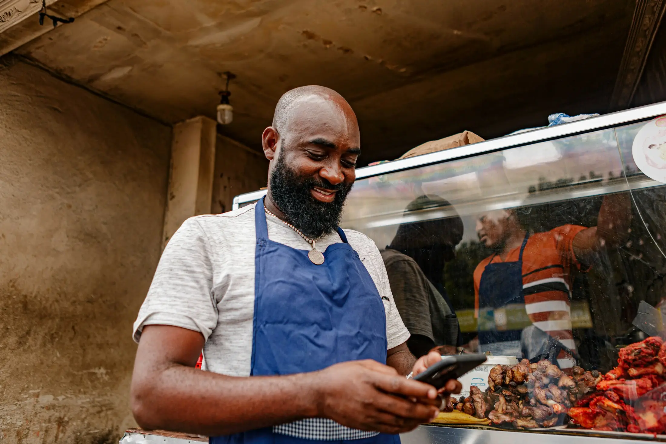 Food business owner checking orders on his phone