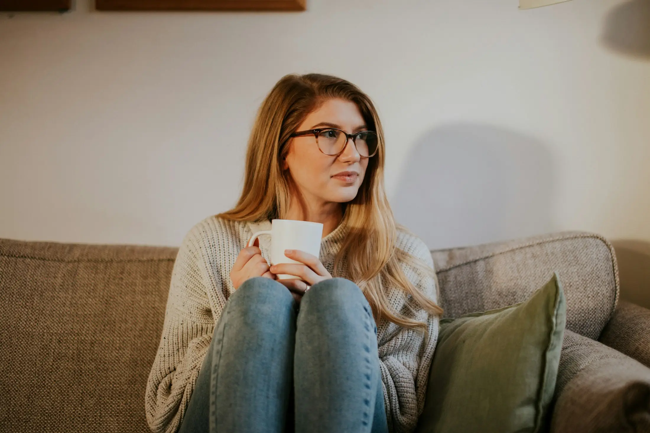 Relaxed woman holding a mug on the couch