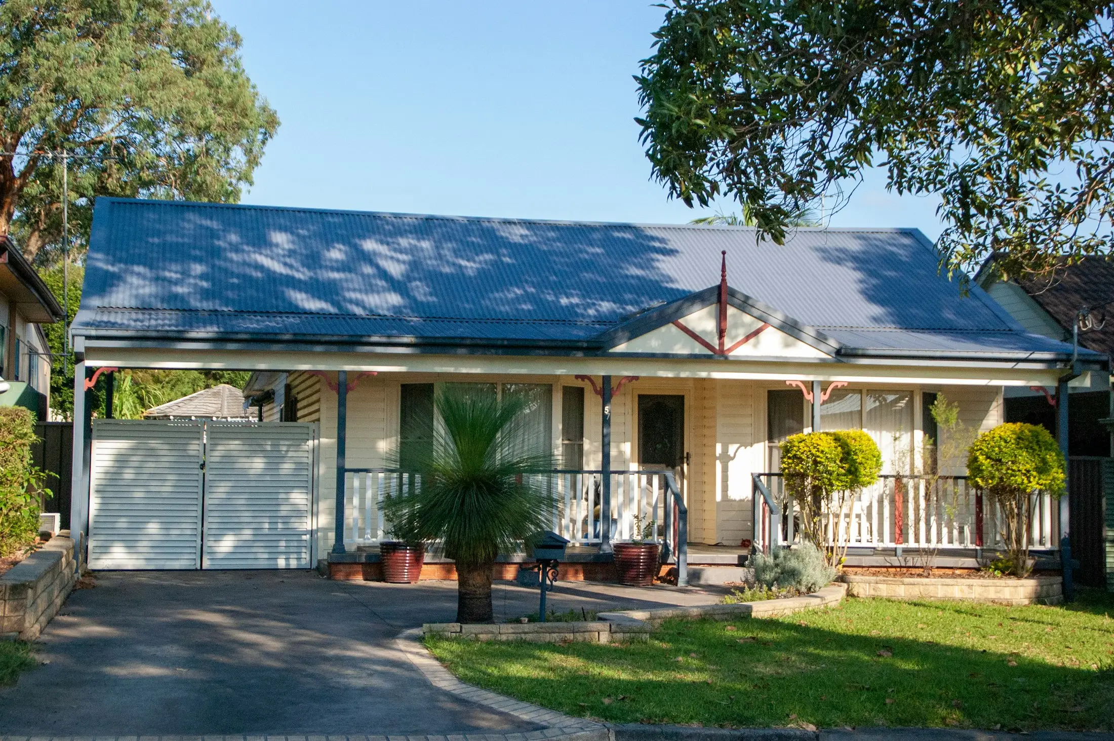 Renovated Australian cottage with a palm in the front garden