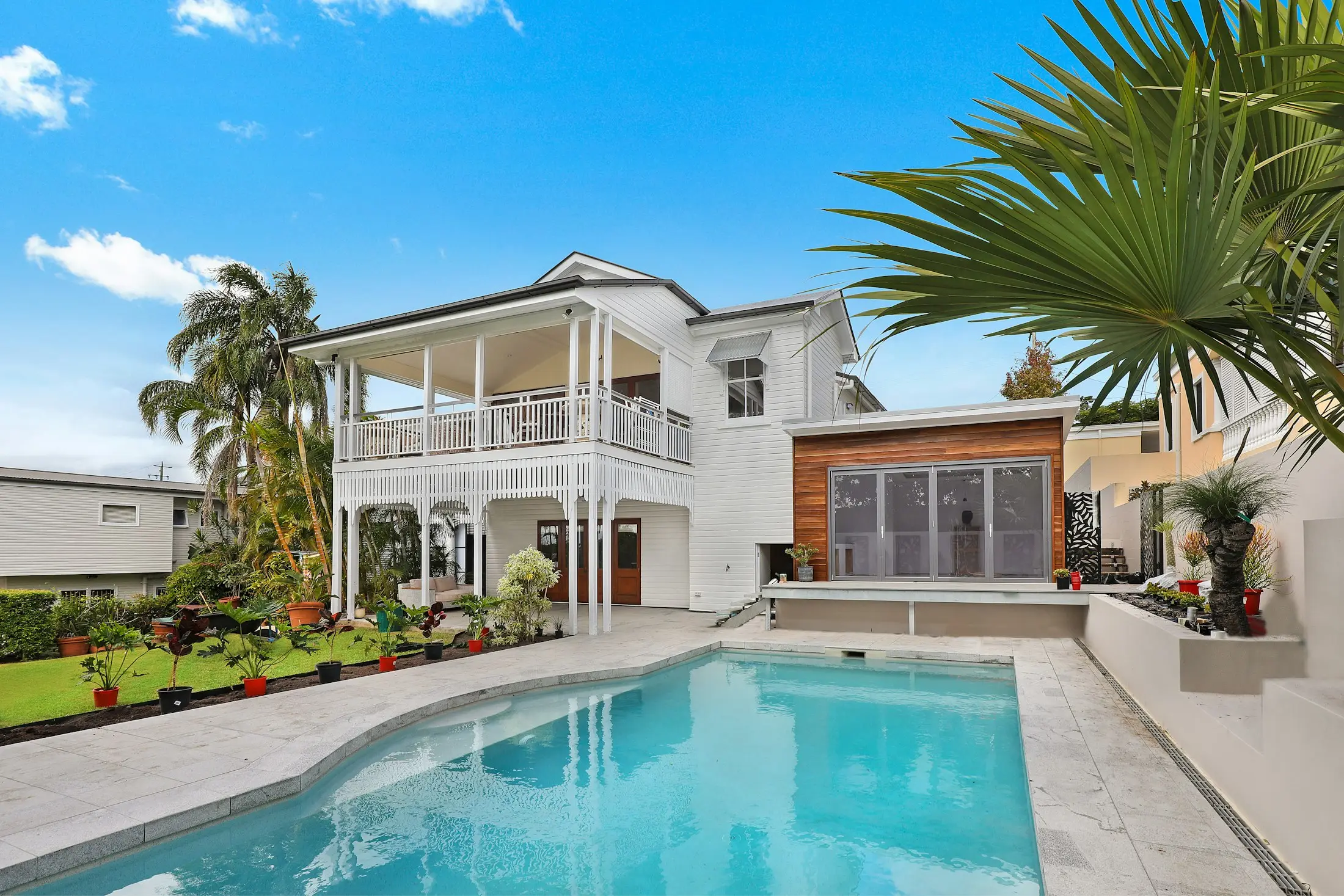 Two-storey Queenslander home with a sparkling in-ground pool